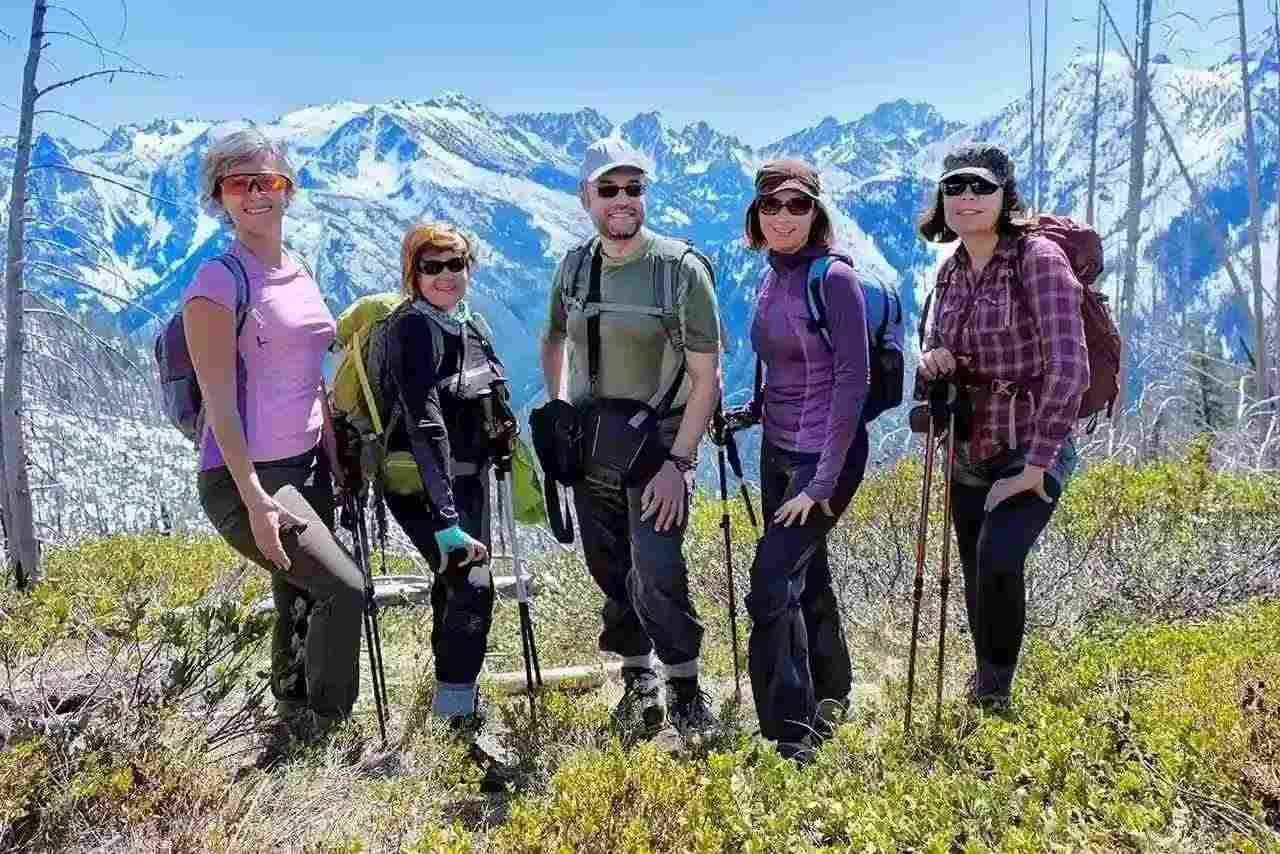 Large group of travelers gathered at an airport for a group trip